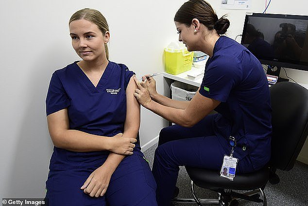 AstraZeneca 's Covid vaccine has been withdrawn globally after admitting it causes adverse side effects, but an Australian expert said fear of the vaccine caused more deaths than it saved. Pictured: Nurses getting a Covid vaccine in Townsville