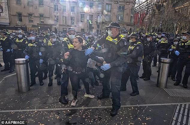 In a shock decision, a judge has ruled that Victoria Police used 'unlawful' and 'unjustified violence' on anti-lockdown protesters during the Covid-19 pandemic. A protester is pictured being removed from a rally in Melbourne