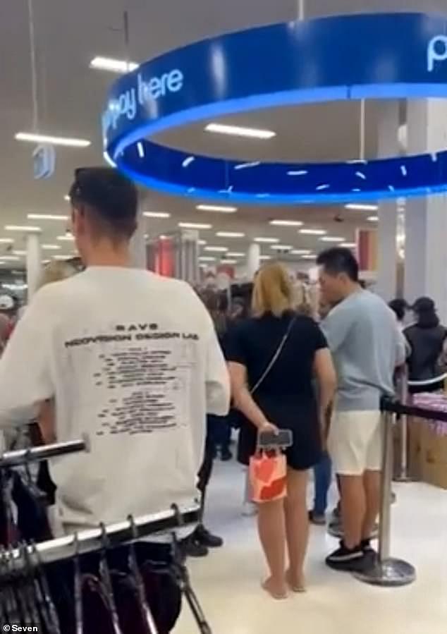The chaos began when a scuffle kicked off between two men, one armed with a knife, at the Westfield Carousel Shopping Centre in the city's southeast at about 3.30pm on Friday (pictured are shoppers locked down in Kmart)