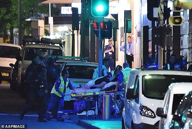 Paramedics are pictured working at the end of the siege at the Lindt Cafe on December 16, 2014