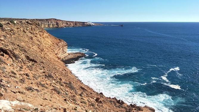 A fisherman has been rescued with just minor injuries after slipping on rocks and falling two metres into the ocean from a cliff near Cape Curvier. 