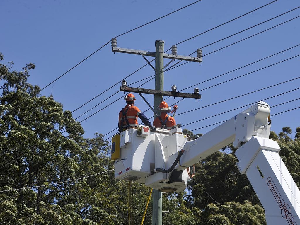 File image: Essential Energy staff work to fix a broken power pole. Picture: Tim Jarrett