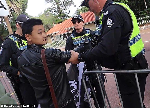 The Tibetan protester was seen being escorted from Kings Park by WA police officers
