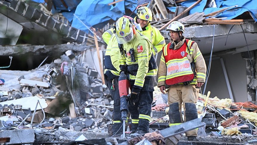 Search crew use jackhammer on rubble at Whalan house explosion