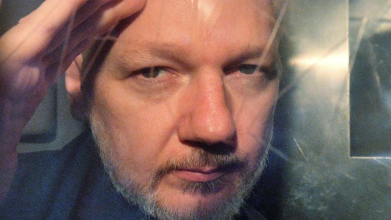 Julian Assange gestures from the window of a prison van. Picture: Daniel LEAL / AFP