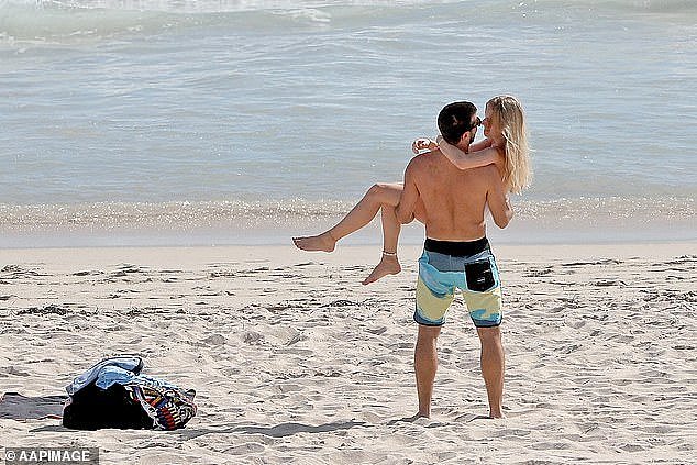 Western Australia is the nation's proverbial boomtown, with a rich economy pulling in a growing swell of Australians and international migrants eager to 'go west' and live the good life. A couple are seen on Scarborough beach in Perth