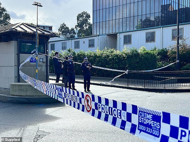 A 14-year-old boy has been arrested and a man has been rushed to hospital after a stabbing sent the University of Sydney into lockdown (police are pictured at the scene)