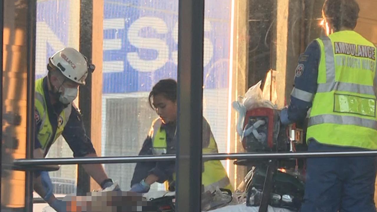 Emergency service workers assisting a woman who fell on the tracks at Punchbowl Station.. Picture: TNV