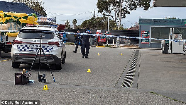 Evidence markers have been placed across the 7-Eleven car park