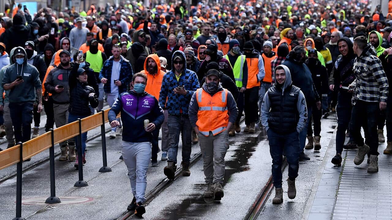 Construction workers are seen at a protest at Construction, Forestry, Maritime, Mining and Energy Union (CFMEU) headquarters in Melbourne, Tuesday, September 21, 2021. (AAP Image/James Ross) NO ARCHIVING