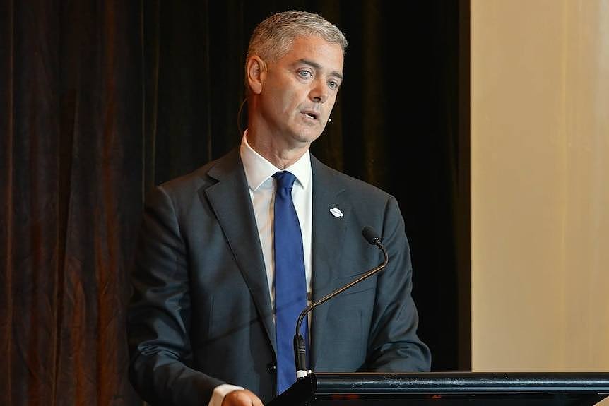 man in suit behind podium