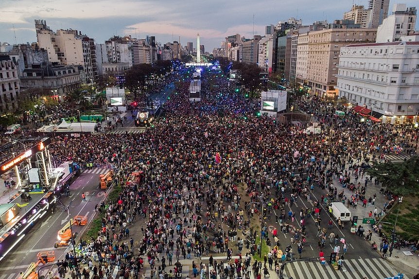 A large outdoor parade with lots of people taking part