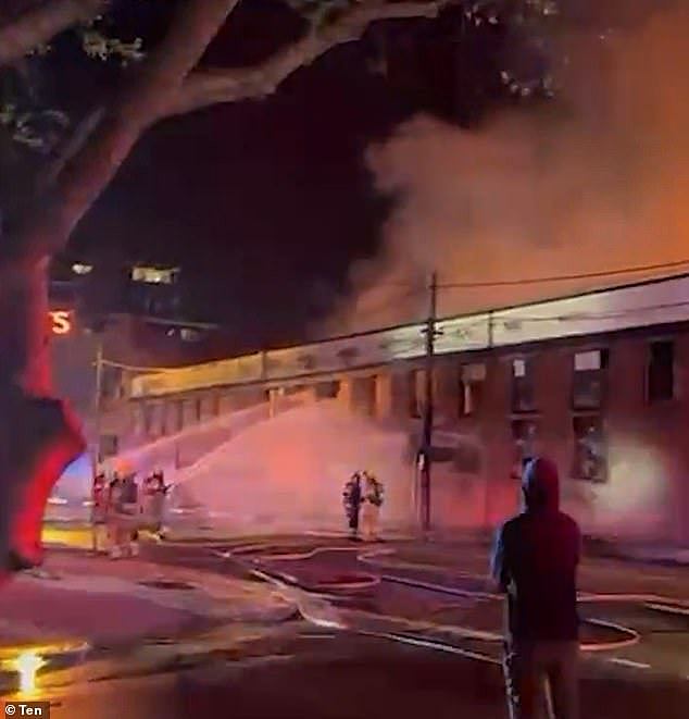 An out-of-control fire is tearing through a factory in Melbourne , sending plumes of smoke into the skies over the city