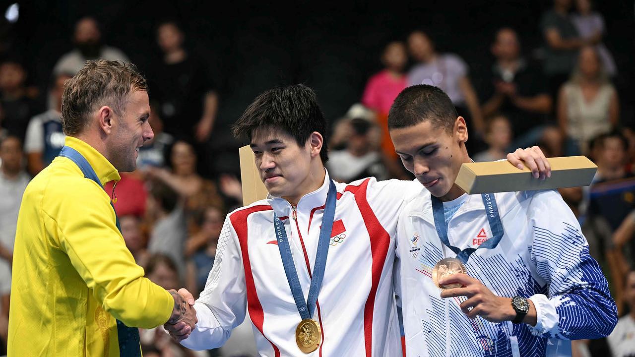 Silver medallist Kyle Chalmers (L), gold medallist Pan Zhanle (C) and bronze medallist David Popovici (R). Photo by Jonathan NACKSTRAND / AFP.