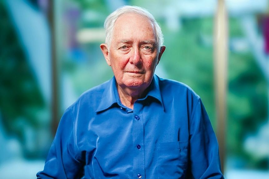 Elderly man wearing a blue shirt. 