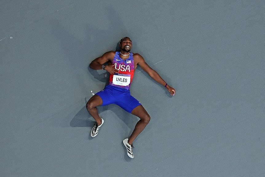 Noah Lyles lies on his back