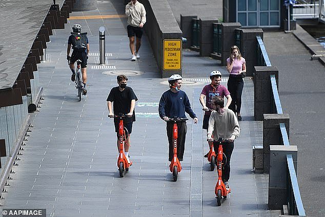 A man running for mayor in the next election said he would let e-scooters stay, but he would reduce their speeds to 12km/h (pictured men on e-scooters in Melbourne)