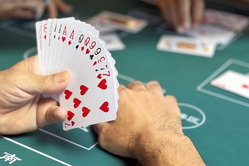 a man holds a deck of cards