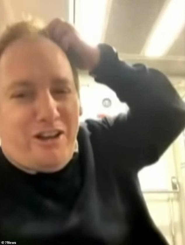 A train guard in Sydney has been stood down after he launched into an expletive-filled rant describing passengers as 'motherf***ers' in a live-stream while he was working (pictured)