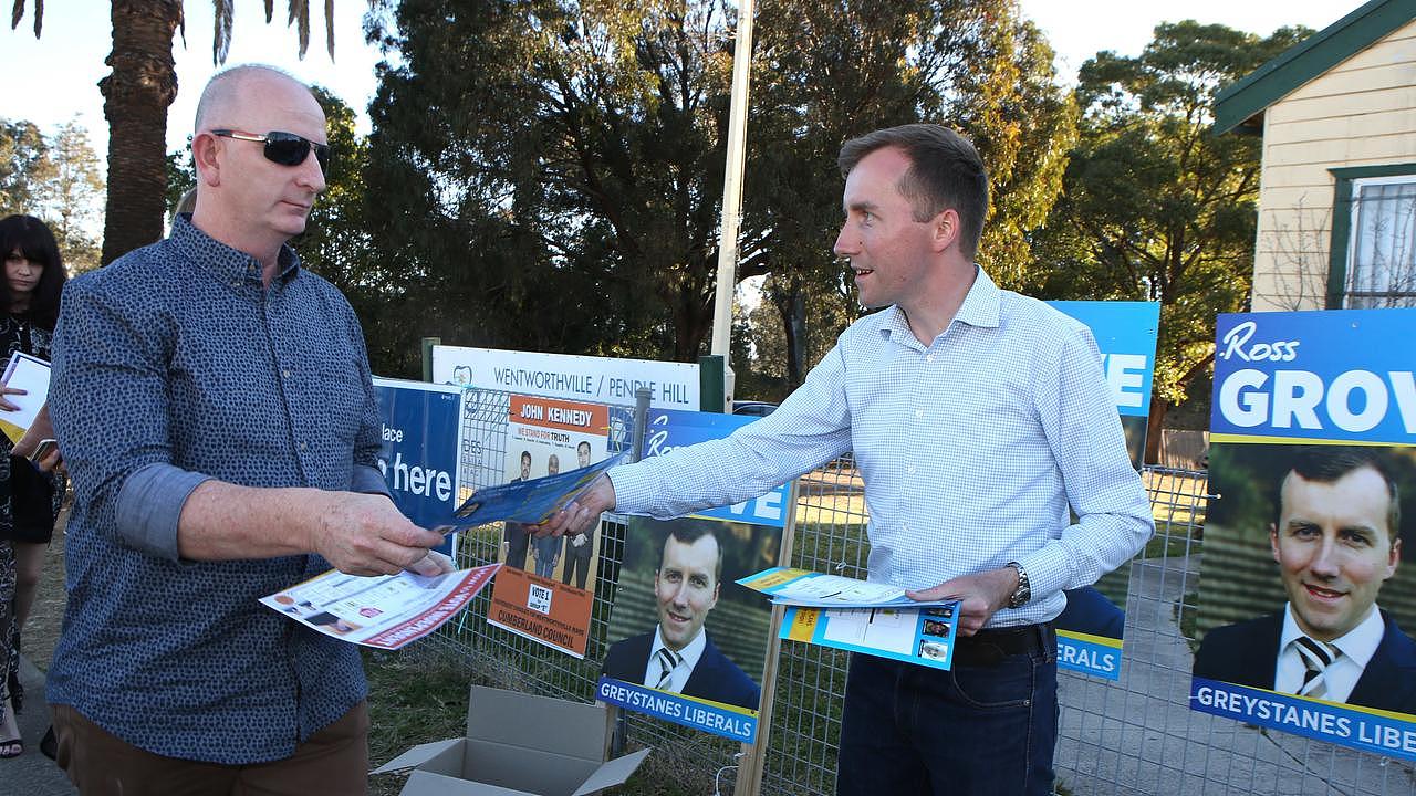 Liberal candidate Ross Grove, standing for Cumberland Council, hands out how to vote cards in Greystanes before the 2017 council elections. Picture: AAP