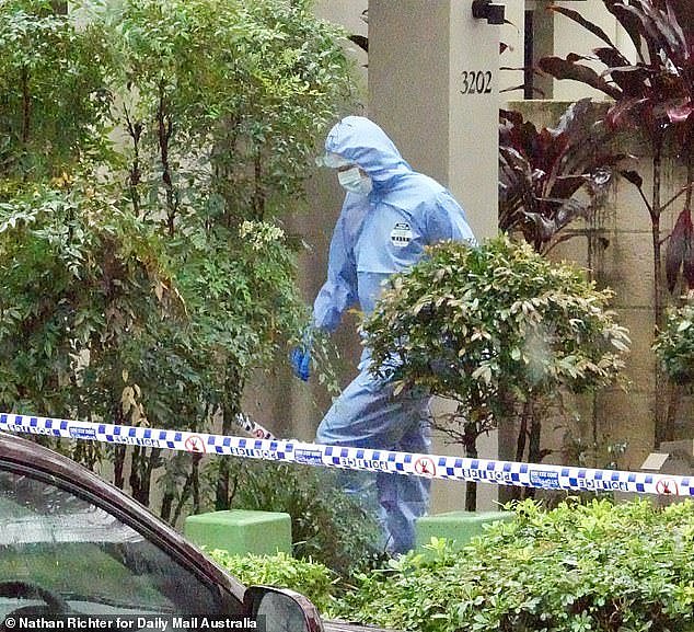 Forensic officers are seen arriving at the home in Carrara on Wednesday following the alleged murder