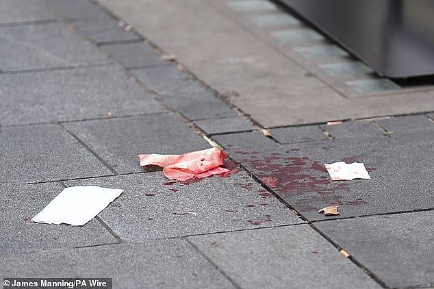 The 11-year-old girl from NSW sustained injuries to her wrist, shoulder, face and neck (pictured, blood on the pavement at the scene in Leicester Square, London)