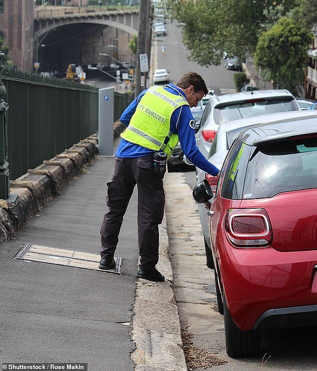 The war against everything going cashless has taken a humorous turn with one outraged Aussie taking a very unusual stance. A parking ticket inspector is pictured