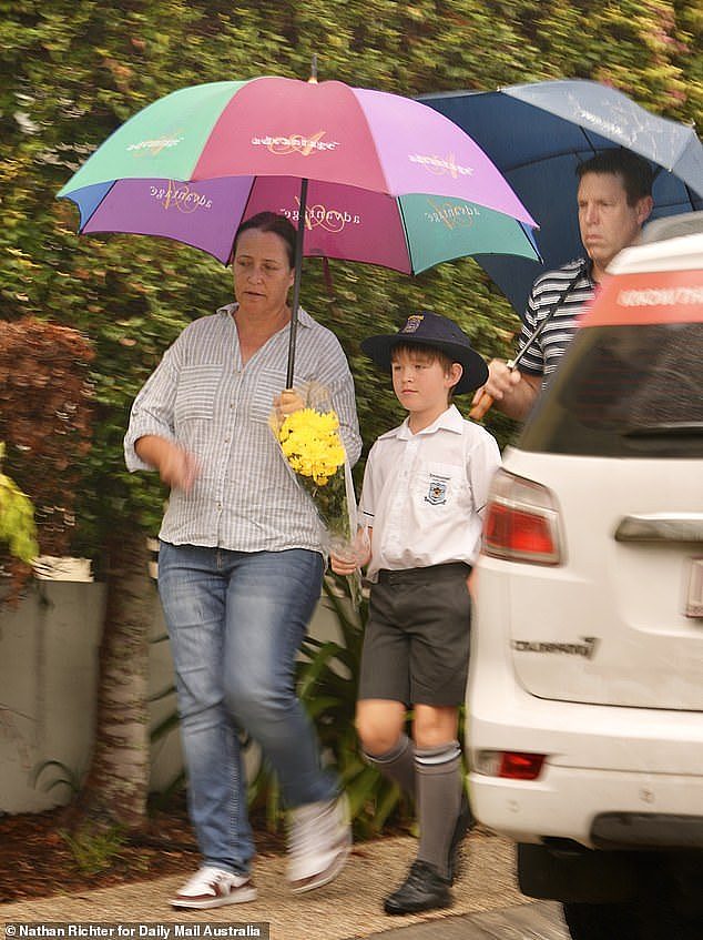 On Thursday morning, several children accompanied by their parents came to lay flowers at the scene on their way to school