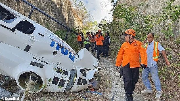 The helicopter went down shortly after 2.30pm local Bali time on Friday (pictured: emergency responders at the site)