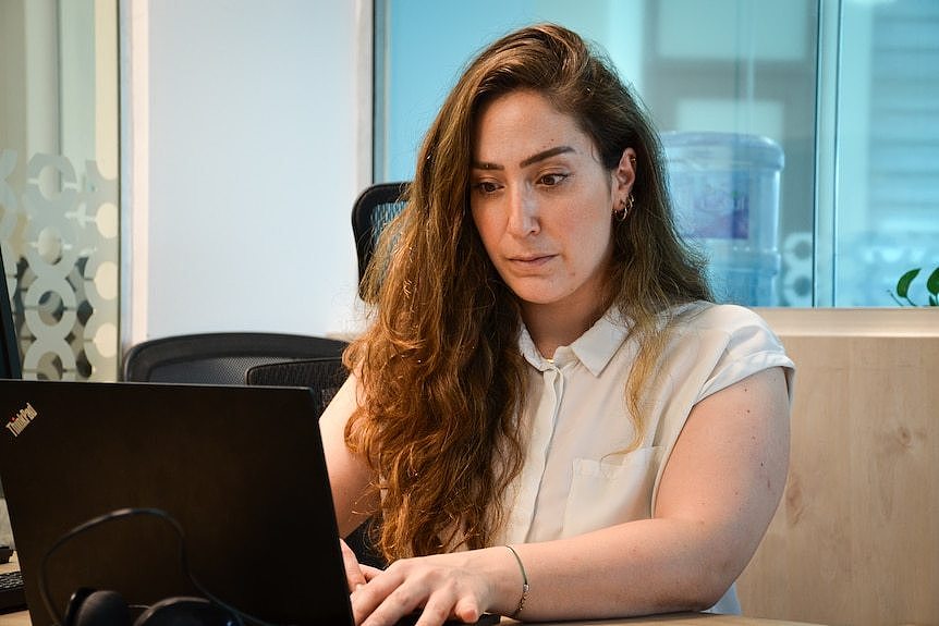 A woman typing on a laptop