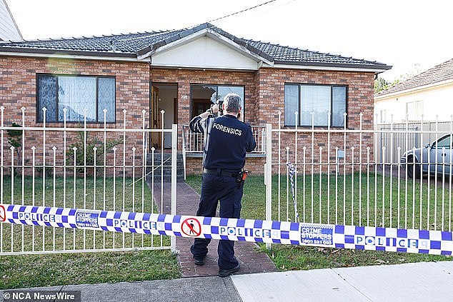 Forensics are seen taking photos of the home on Antwerp street that was shot at hours earlier