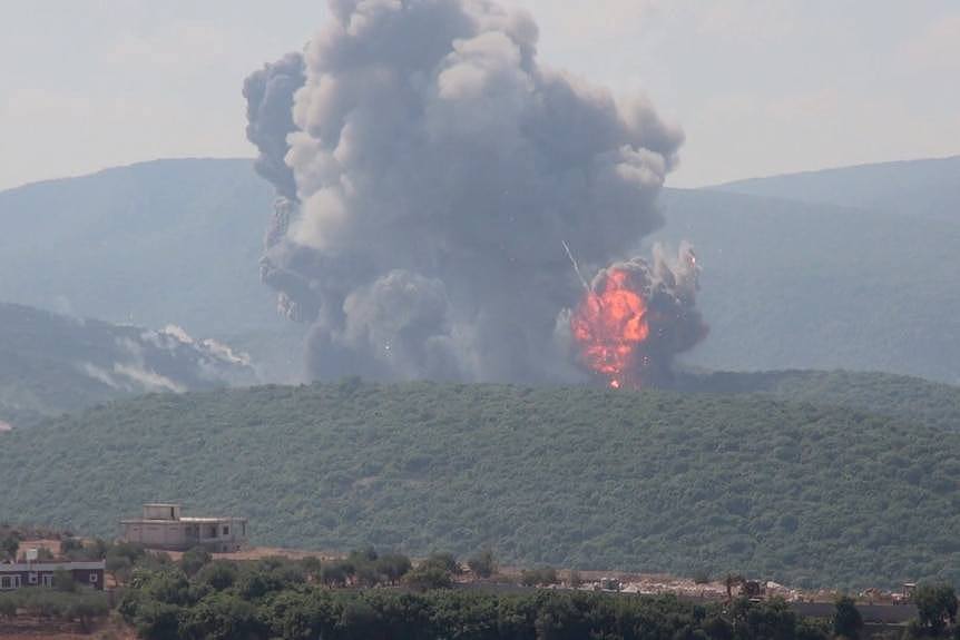 Large explosion and fireball seen on hill in distance