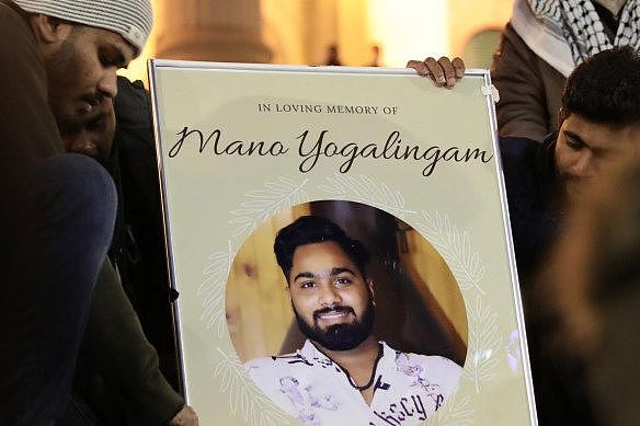 Mourners hold an image of Mano Yogalingam, who took his own life. 