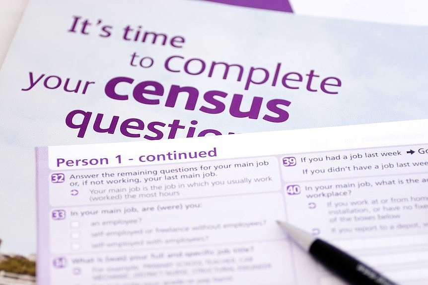 Pen over purple and white census forms.