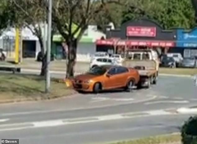 A man pretending to be a fake tow truck driver stole a Holden Commodore that was parked outside a shopping centre in Logan, south of Brisbane, on Tuesday