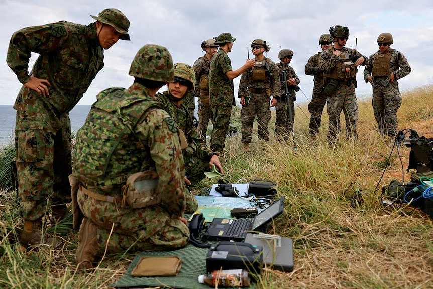 A group of Japanese defence soldiers on the ground