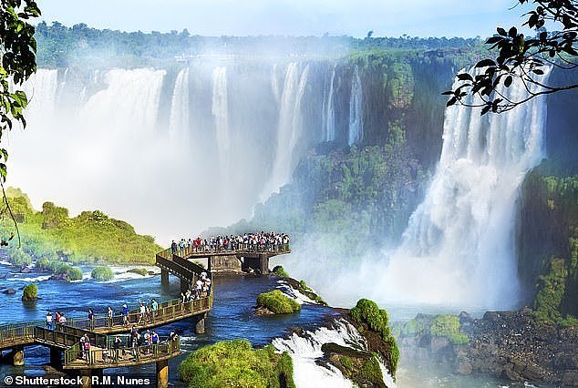 Tourists at Iguazu Falls, one of the world's great natural wonders, on the border of Brazil and Argentina