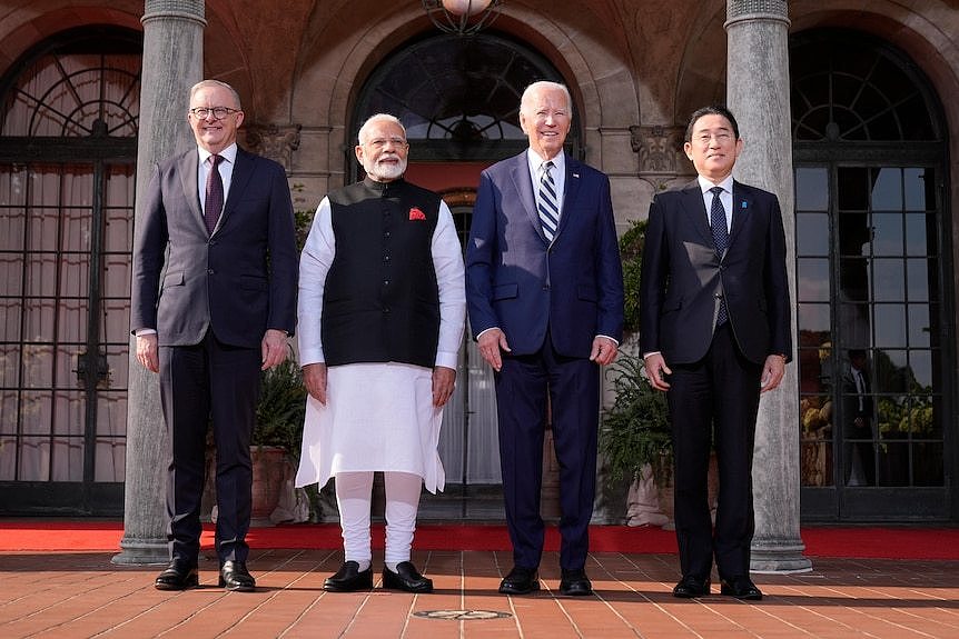 Anthony Albanese, Narenda Modi, Joe Biden and Fumio Kishida stand in a line next to each other.