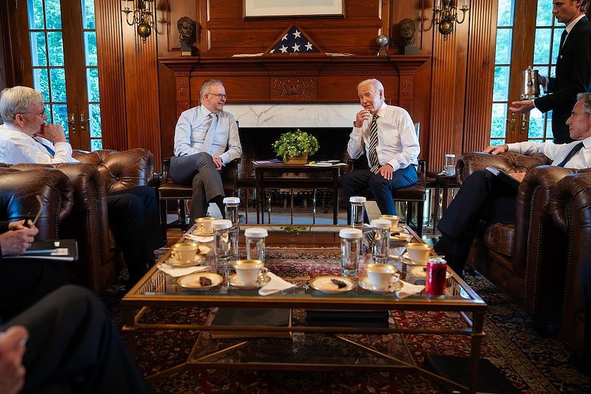 Mr Albanese and Mr Biden sitting on lounge chairs.