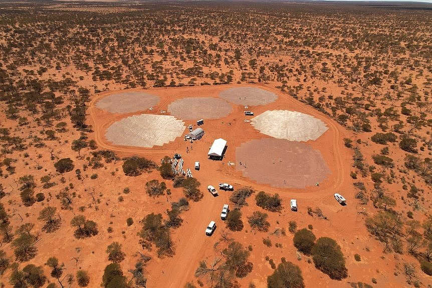 An aerial drone shot of a facility being built in the WA outback, with lots of red dirt surrounding. 