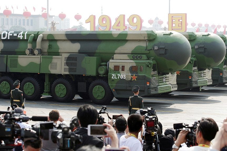 Large missiles in camo paraded in front of crowd