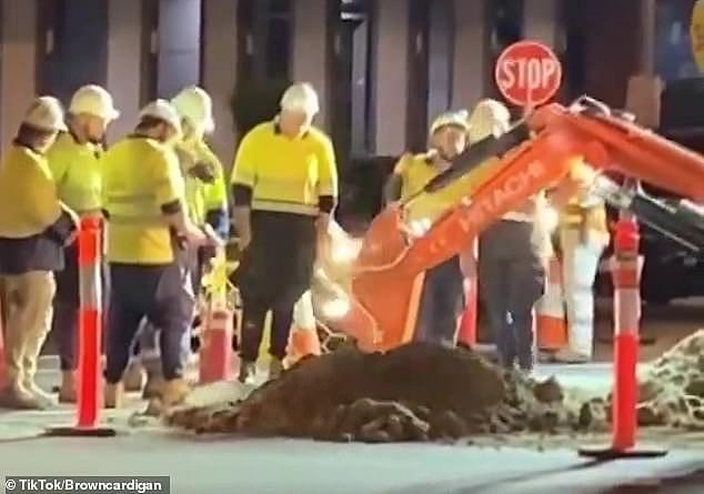 Aussies are frustrated at road workers 'standing around' while they get paid high wages (pictured the video of the workers posted on social media)