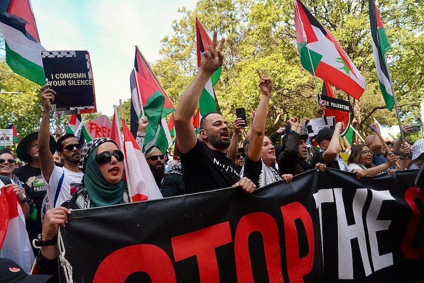 People marching and carrying signs and flags