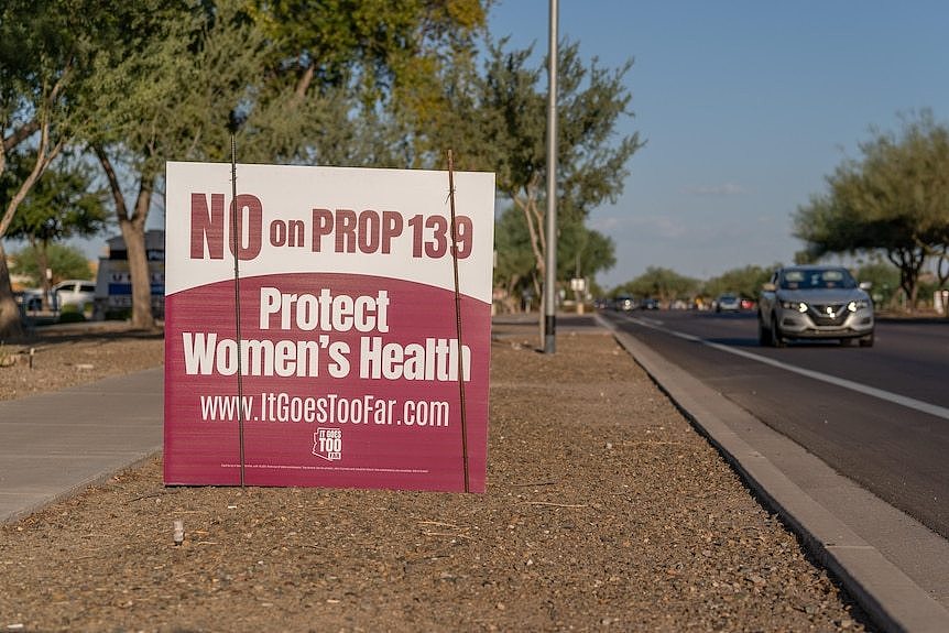 A sign reading 'No on Prop 139 PROTECT WOMEN'S HEALTH' 