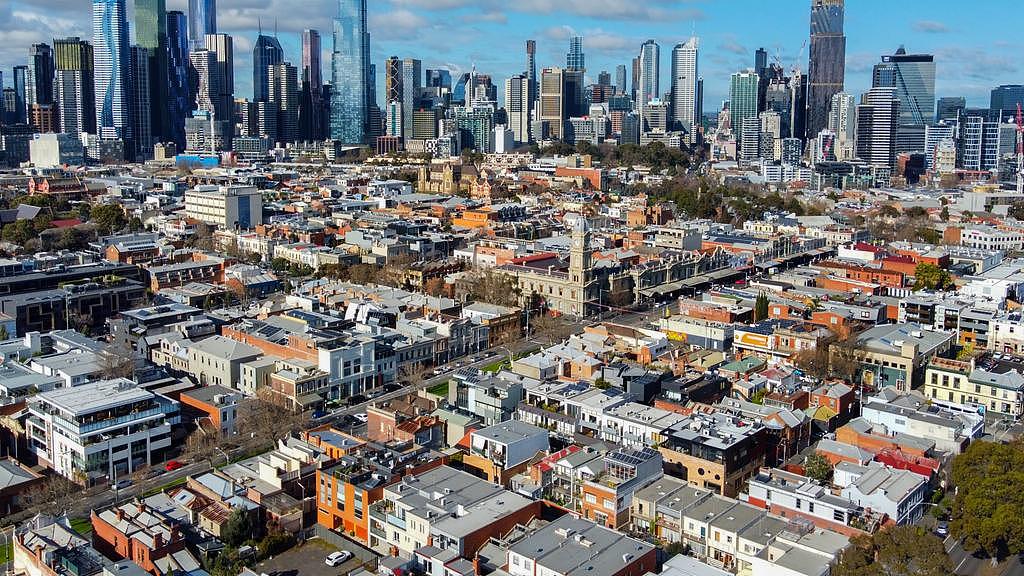 Aerial view of houses and apartments in North Melbourne, looking towards the Melbourne city skyline