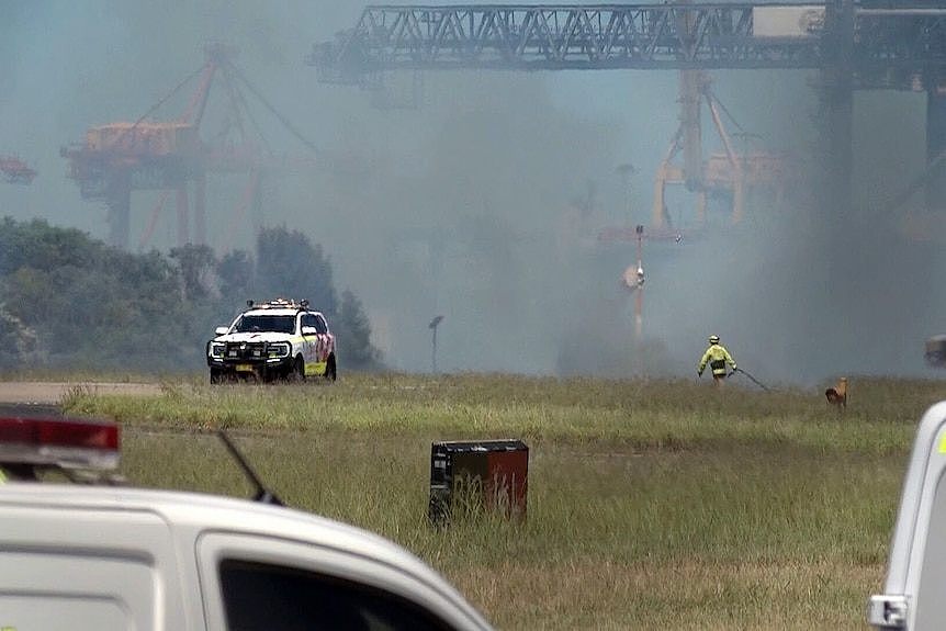 emergency personnel rush to a grass fire near a runway at sydney airport sparked by engine failure from a qantas plane