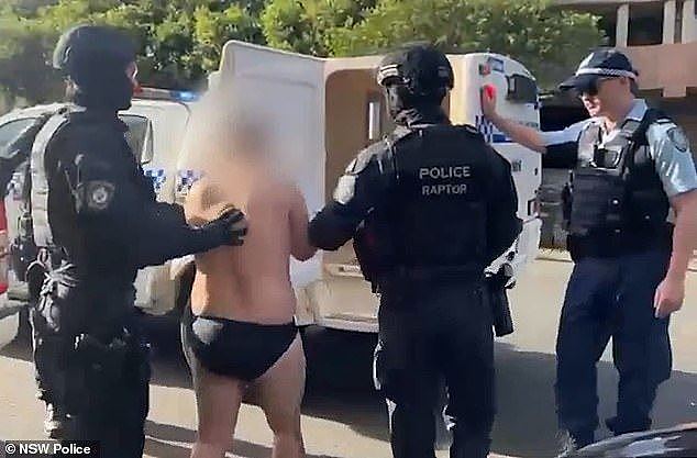 In video of the arrest, the man is seen being walked out the unit block by Strike Force detectives while barefoot and wearing only his underwear (pictured)