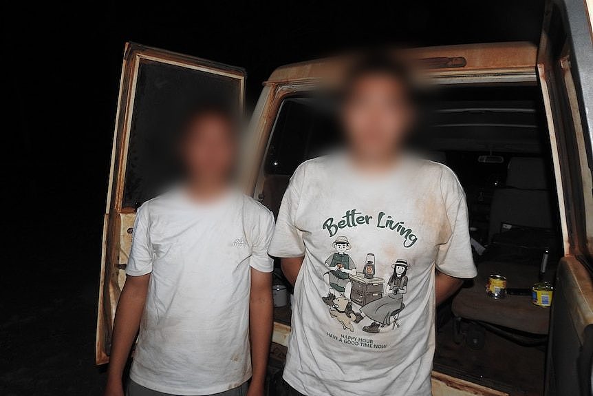 two chinese men standing next to each other with their faces blurred