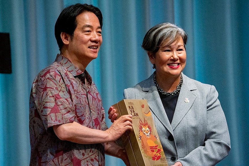 Taiwanese President Lai Ching-te, left, presents a gift to East-West Center President Suzanne Vares-Lum 