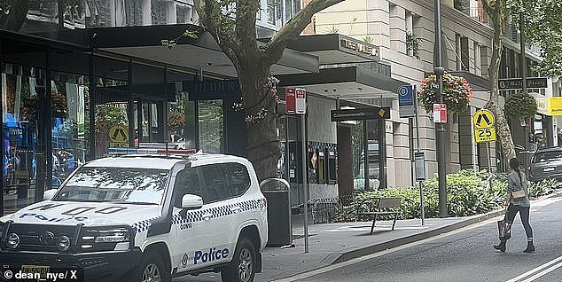 A Commonwealth Bank branch in the inner-eastern Sydney suburb of Potts Point was reportedly locked down on Friday over a 'bomb threat' just days after a $3 cash withdrawal charge caused public backlash. A police vehicle is pictured at the scene